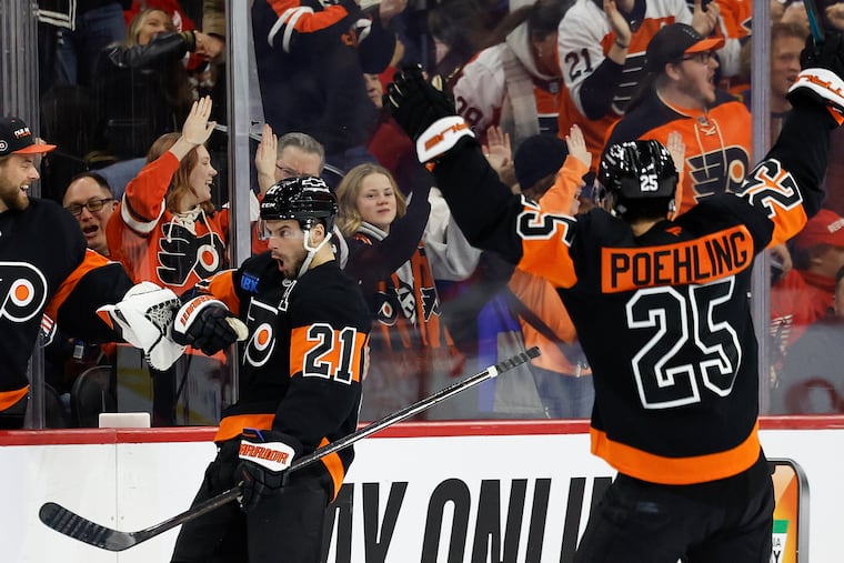 Flyers center Scott Laughton (center) celebrates his second period goal with his teammates.