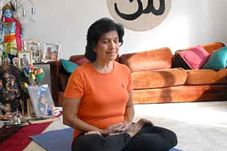 Veena Gandhi practices yoga in her Voorhees, N.J., home in this photo taken on Nov. 17, 2018. ( APRIL SAUL / Staff Photographer )