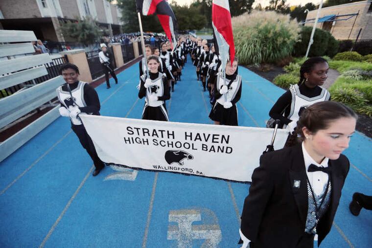 Over 400 members of Strath Haven High School's marching band take the field during an away game at Springfield High School Friday September 15, 2017.