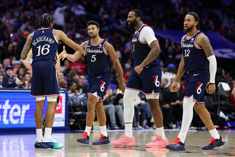 Philadelphia 76ers guard Quentin Grimes (5) reacts with MarJon Beauchamp after making two consecutive steals for baskets during the fourth quarter at Xfinity Mobile Arena on Sunday, March 15, 2026, in Philadelphia.