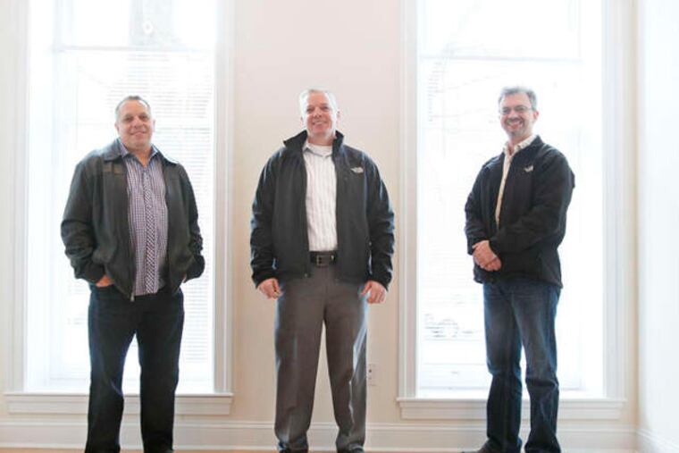 Loonstyn brothers (from left) Joe, John, and Bill have developed two late-19th-century houses on Spring Garden Street at 21st Street. The nine-foot-tall windows were original and have been upgraded with insulated glass.