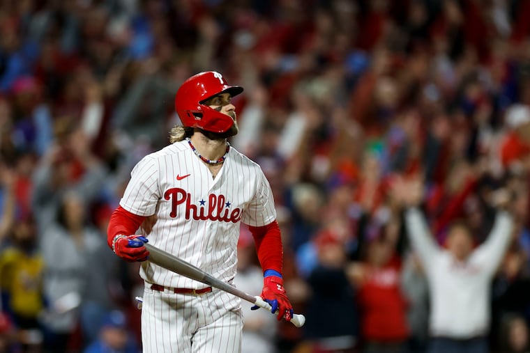 Bryce Harper watches his solo home run in the first inning of Game 1 of the NLCS.