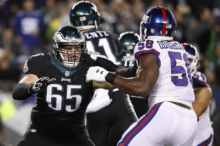 Lane Johnson (left) blocks the Giants’ Owa Odighizuwa during a game last season.