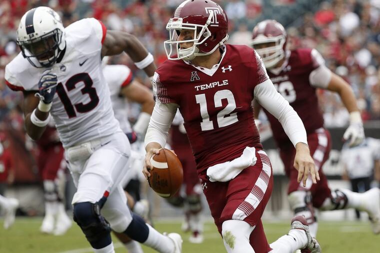 Temple’s quarterback Logan Marchi, right, keeps the ball as UConn’s Vontae Diggs, left, gives chase in the 2nd quarter as the Temple Owls play the UCONN Huskies in Philadelphia, PA on October 14, 2017. DAVID MAIALETTI / Staff Photographer