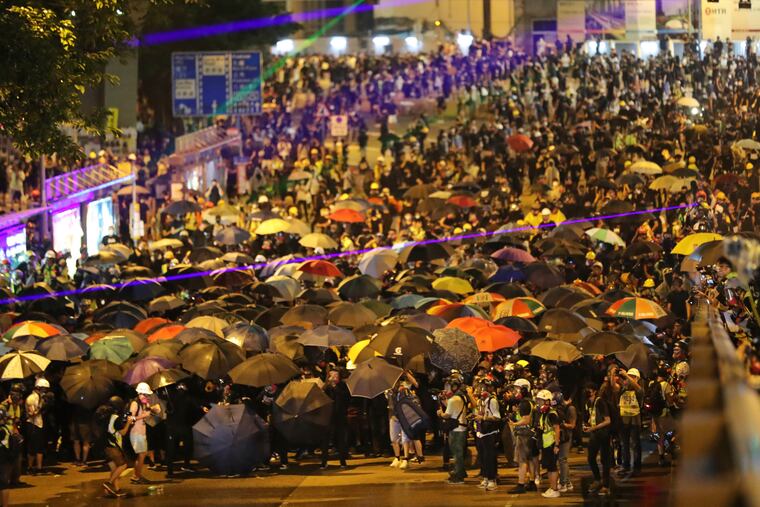 Protestors crowd a street in Hong Kong, Saturday, Sept. 28, 2019. A pro-democracy rally in downtown Hong Kong has ended early amid sporadic violence, with police firing tear gas and a water cannon after protesters threw bricks and Molotov cocktails at government offices.