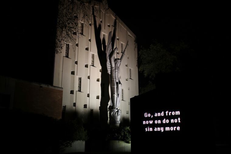 An illuminated sign outside St. Michael Archangel Catholic Church in Houston reads, "Go, and from now on do not sin any more" on April 11, 2019. The church, which has been grappling for decades with the sexual abuse of children, is now being forced to reckon with the recognition that adults too can be sexually exploited by clergy. (AP Photo/Wong Maye-E)