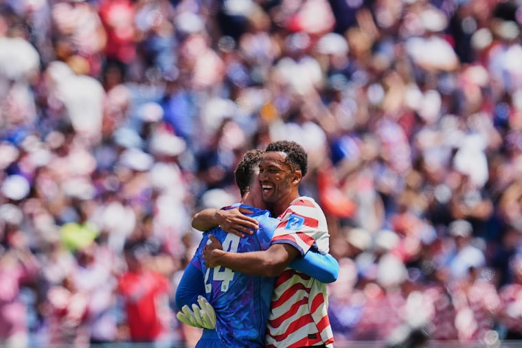 Wayne's Matt Freese (left) and Media's Auston Trusty embracing after the U.S.' win over Australia on Friday.