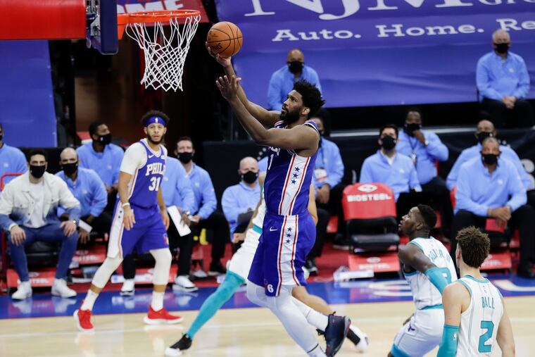 Sixers center Joel Embiid lays-up the basketball against Charlotte on Monday.