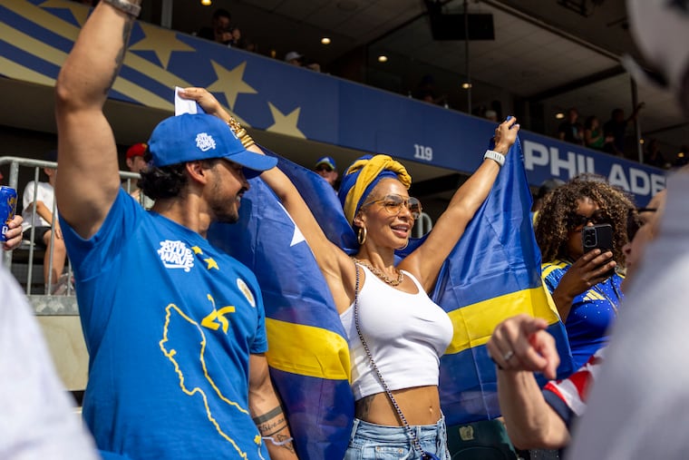 Juliska Koolman, of Atlanta, Ga., is cheering on Curaçao with her son Matthew Hernandez, of Newark, N.J., (left), at the start of the Curaçao vs Ivory Coast on Thursday.