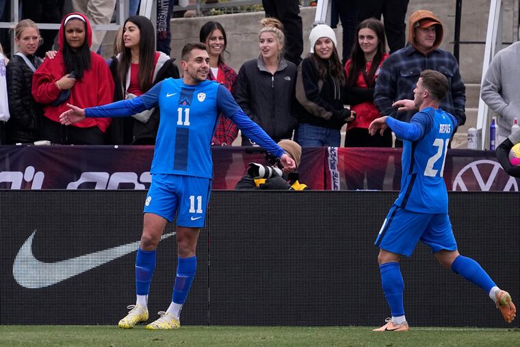 Slovenia forward Nejc Gradišar (11) celebrates his goal with teammate Matija Kavčič (21) during the first half on Saturday in San Antonio.