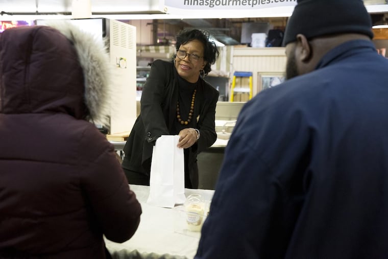 Owner Nina Bryan sells Sweet Nina’s banana pudding from a day stall/cart at Reading Terminal Market.