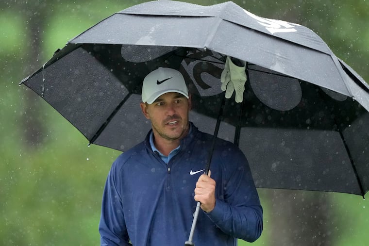 Brooks Koepka waits to play on the seventh hole during the weather-delayed third round of the Masters at Augusta National Golf Club on Saturday. Koepka is atop the leaderboard at 13-under heading into Sunday.