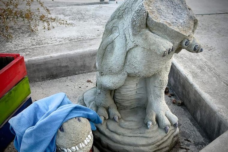 Bridget the Dino, a beloved stone garden statue at the Manayunk Bridge Garden, had its head smashed off between late Saturday night and early Sunday morning. The 300-pound stone statue would be hard to move, neighbors say, leading some to believe an adult purposefully broke the statue.