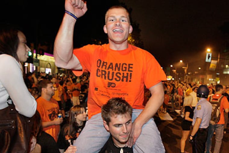 Fans jammed Broad Street near Shunk after the game to celebrate the Flyers' win. (Elizabeth Robertson/Staff Photographer)