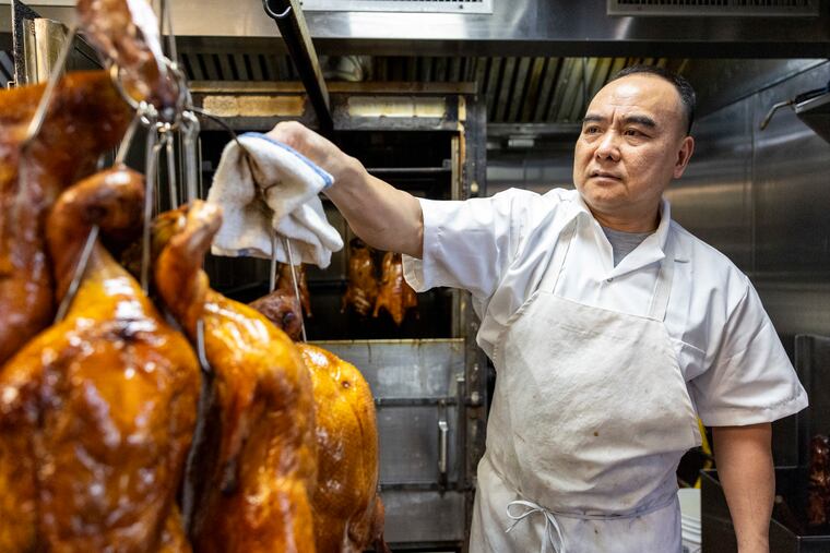 Chuien Liu, owner of Lau Kee, takes cooked ducks from the oven in Philadelphia, Pa., on Friday, Aug. 7, 2026.