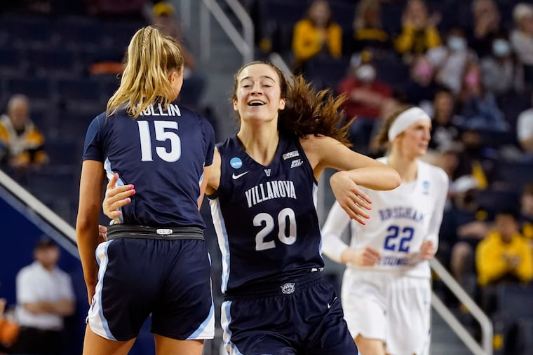Villanova forward Maddy Siegrist (20) celebrates her 3-point basket with guard Brooke Mullin (15) during the second half of a college basketball game in the first round of the NCAA tournament against BYU, Saturday, March 19, 2022, in Ann Arbor, Mich. (AP Photo/Carlos Osorio)