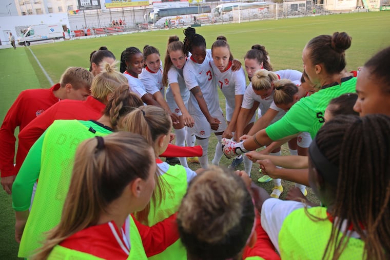 Players of the Canadian women's soccer team on the sideline before kickoff of a friendly game against Argentina in Spain last October.