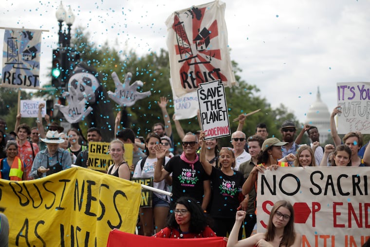 Protesters block traffic near the U.S. Capitol in Washington, Monday, Sept. 23, 2019. A broad coalition of climate and social justice organizations are disrupting the morning rush hour commute. (AP Photo/Pablo Martinez Monsivais)