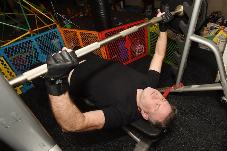 Brett Rubinson works out in his home gym in Penn Valley.