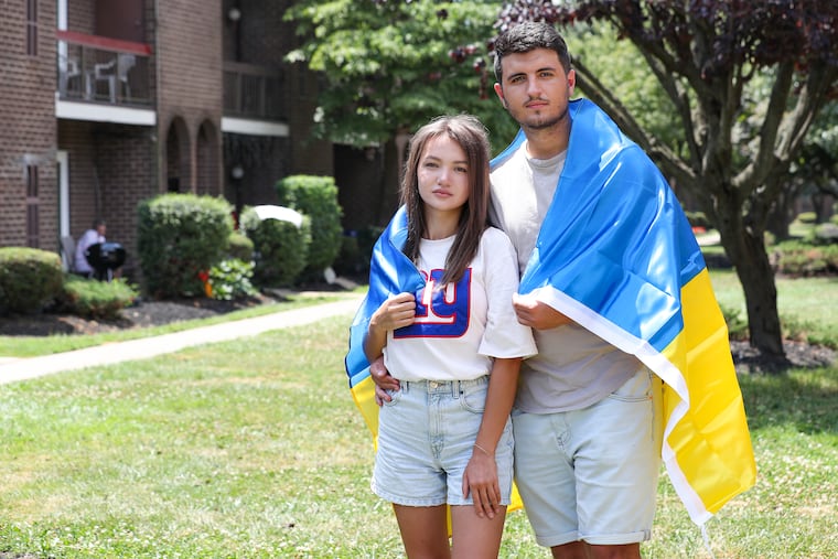 Valentyn Khimchuk and his girlfriend, Roksolana Tokarevych, left, both 21, outside the home of an uncle in Northeast Philadelphia. Khimchuk and Tokarevych arrived in the U.S. from Ukraine on July 8. Six days later they applied for work permits.