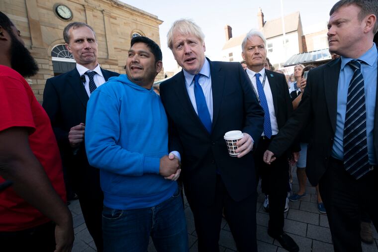Britain's Prime Minister Boris Johnson shakes hands with a member of the public during a visit to Doncaster Market, in Doncaster, Northern England, Friday Sept. 13, 2019. Johnson will meet with European Commission president Jean-Claude Juncker for Brexit talks Monday in Luxembourg.