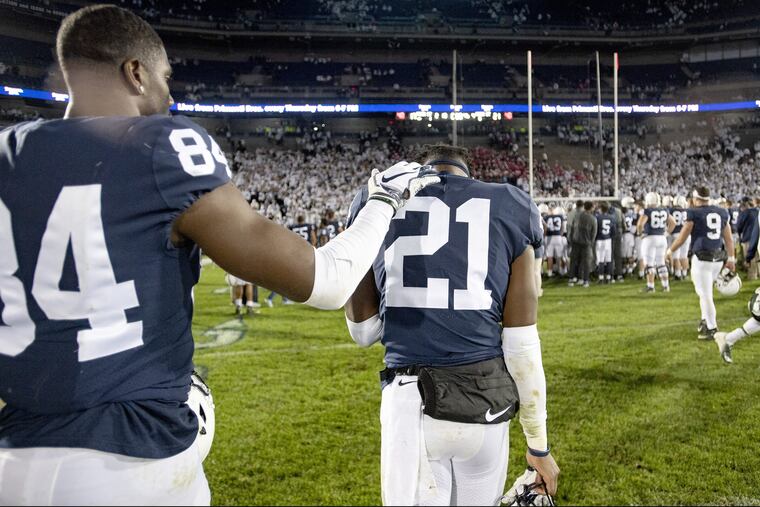 Penn State's Juwan Johnson (84) tries to comfort cornerback Amani Oruwariye after a 21-17 loss to Michigan State at Beaver Stadium on Saturday.