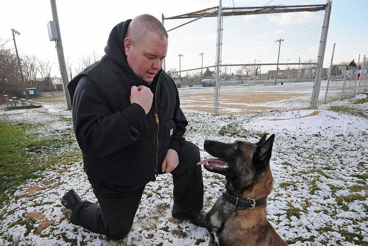 Officer Gene Mackey and his dog, Sarge, in Folcroft in 2013. "We were there so fast, they didn't have time to meet us with a stretcher," he said of Saturday's gun accident involving a 10-year-old. (APRIL SAUL / File photo)