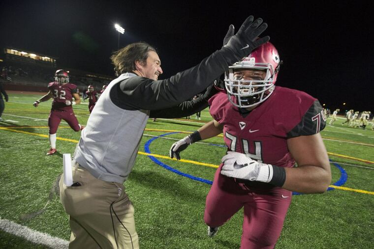 Coach Gabe Infante, left, and Casey Stephenson, right, celebrate St. Joseph's Prep 17-3 victory over La Salle in the Catholic League 6A championship on Nov. 10, 2017.