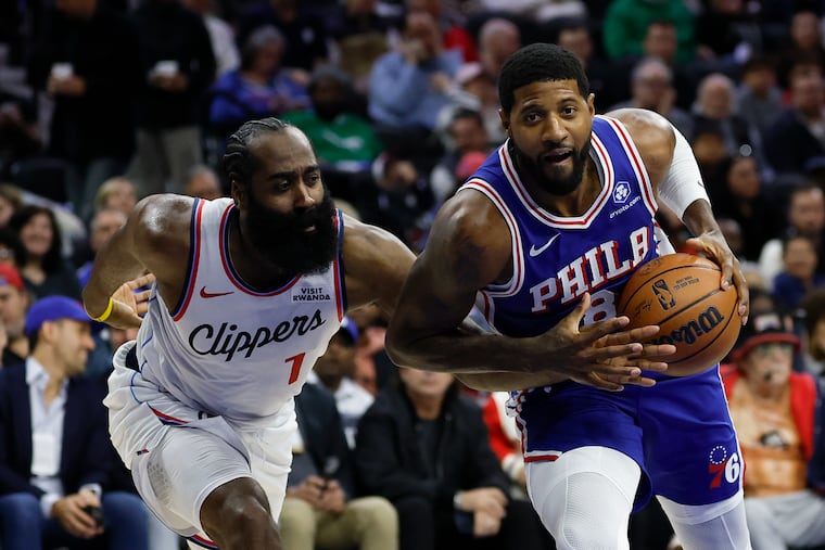Sixers forward Paul George (8) drives to the basket past Los Angeles Clippers guard James Harden on Monday.