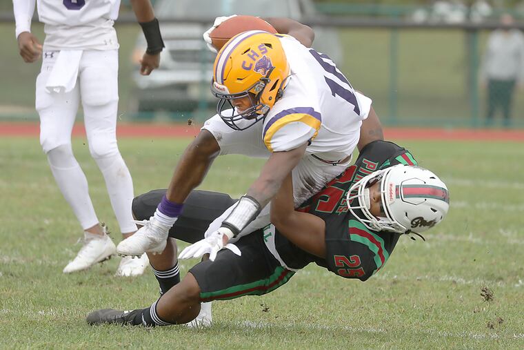 Camden's Dashaun Harris is tackled by Cedar Creek's Jaylen Glover in the first quarter.