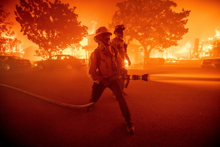 Firefighters battle a fire in the Pacific Palisades neighborhood, Jan. 7, 2025. A new report by Swiss Re Institute said about $40 billion in losses from the Los Angeles fires are part of the $145 billion in insured losses expected this year.