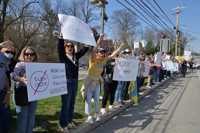 A March demonstration against Elon Musk and the Department of Government Efficiency in Devon. Anne Krawitz urges Philadelphia lawmakers to cease all investments in Musk's electric car company, Tesla.