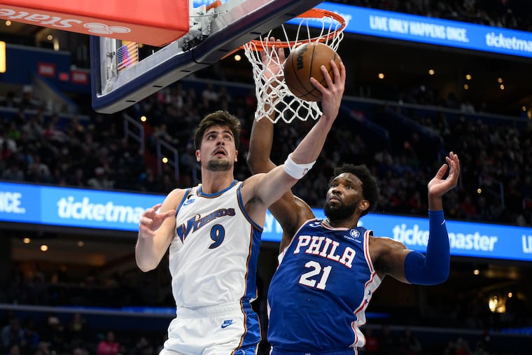 Washington Wizards forward Deni Avdija goes to the basket against 76ers center Joel Embiid during the first half Tuesday.