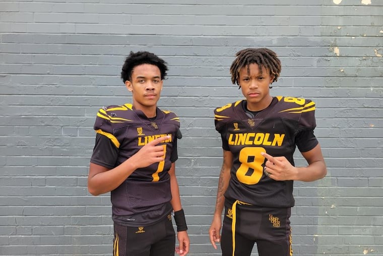 Lincoln's Kareem Moore (left) and Nymir Marable (right) after its team beat Imhotep, 26-25, in the regular season finale. Lincoln advances to the postseason.