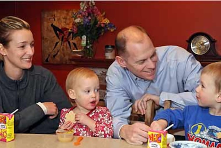 USAF Captain Andrea Hooper and husband Marine Lt. Col. Will Hooper are both military reservists. With them are their children Henry, 4, right and Adeline, 2, left. (Steven M. Falk Staff Photographer)