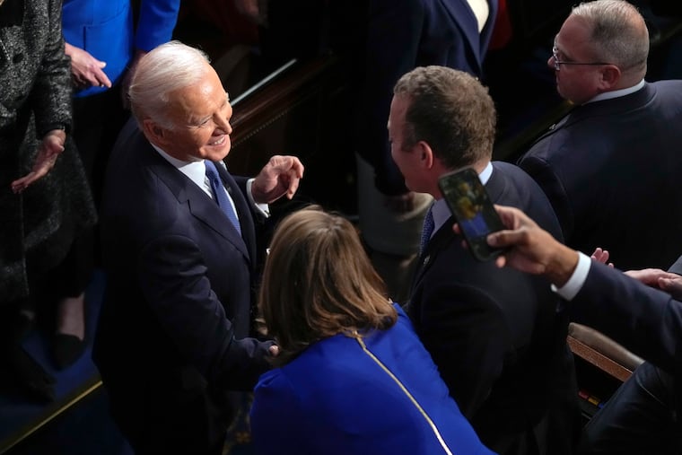 President Joe Biden greets lawmakers as he arrives in the House chamber to deliver the State of the Union address to a joint session of Congress at the U.S. Capitol Tuesday night.