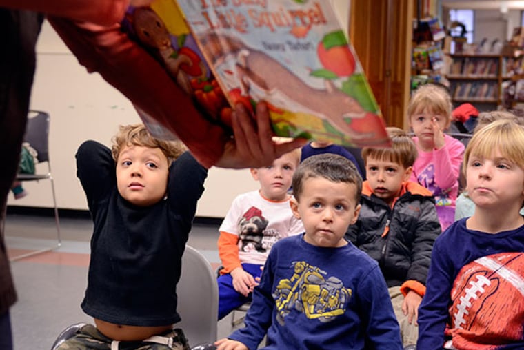 Haddonfield Public Library's children's librarian, Dorothy Peppard reads to a couple classes of kids from the First Presbyterian Church Preschool Program at the library December 5, 2013. ( TOM GRALISH / Staff Photographer )