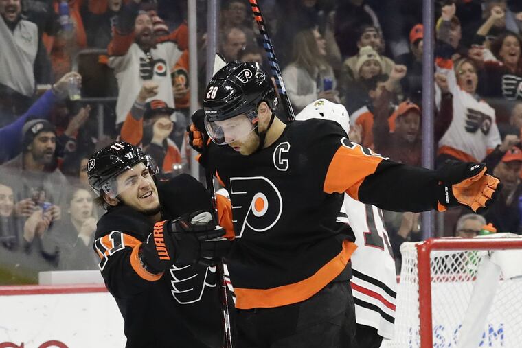 Flyers center Claude Giroux celebrates his first-period goal with teammate right wing Travis Konecny against the Chicago Blackhawks on Saturday, November 10, 2018 in Philadelphia. YONG KIM / Staff Photographer