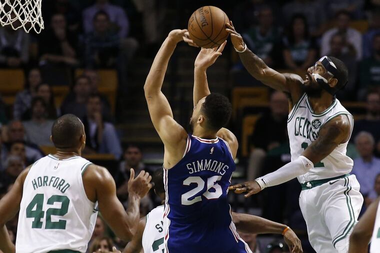Boston Celtics star Kyrie Irving blocks a shot by the Philadelphia 76ers’ Ben Simmons during the fourth quarter of Boston’s 108-97 win.