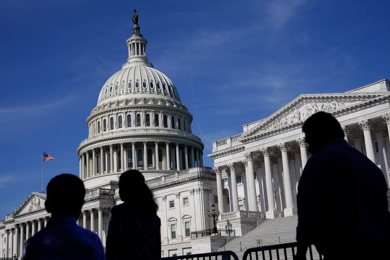 People walk outside the U.S. Capitol building in Washington in 2022.