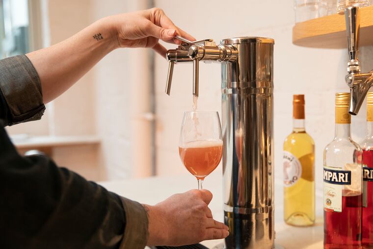 The Maloof skin contact pinot gris getting pored into a glass served at Pizzeria Beddia in Fishtown on Thursday, May 23, 2019.