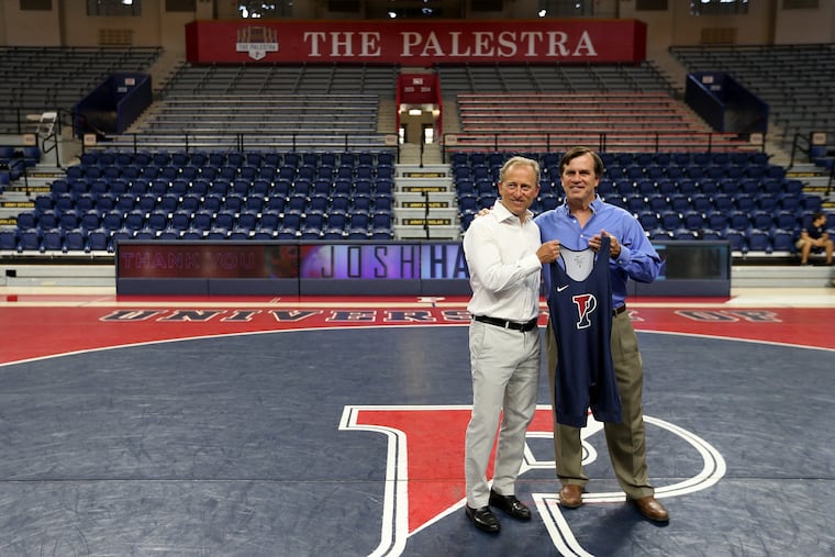 Sixers owner Josh Harris (left) with Penn wrestling coach Roger Reina after he announced a $1 million gift to Penn wrestling.