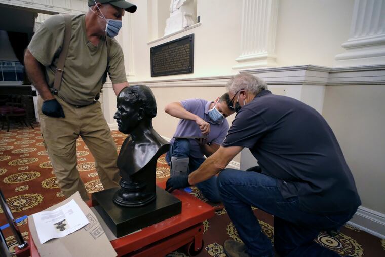 Workmen prepare to haul away a bust of Matthew Fontaine Maury in the Old House Chamber inside the Virginia State Capitol in Richmond, Va., Thursday, July 23, 2020. All busts and plaques relating to the Confederacy were removed.