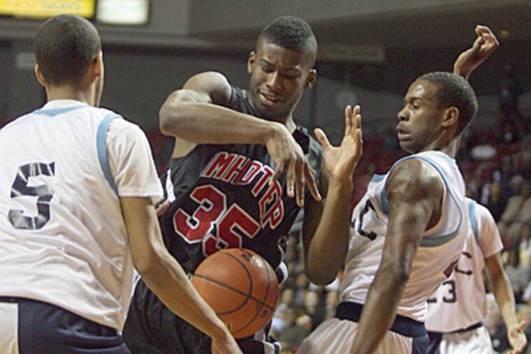 Imhotep Charter's Jamal Jones, center, loses the basketball against Franklin Learning Center's Karl Riley, left, and Denzel Yard in the first quarter of Friday night's Public League boys' championship game at the Liacouras Center. (Yong Kim / Staff Photographer)