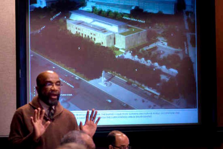 Art Commission chairman Moe Brooker tells spectators at the hearing to address only the building's design, not the move.