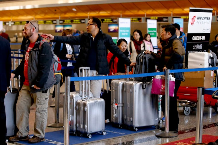 Travelers line up at the check-in counter for Air China inside the Bradley Terminal at Los Angeles International Airport on Jan. 11, 2015. Foreign travelers are now required to pay up to $15,000 for a reimbursable bond when applying for a U.S. visitor visa.