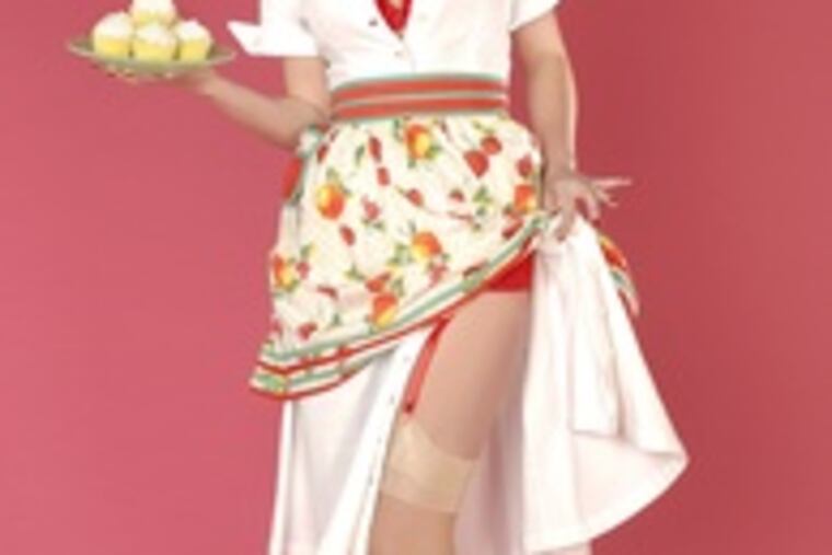 Cheyenne McGarvey strikes another pose for the pinup photos for her fiance. Giuliano, whose studio is a cavernous Overbrook loft, boasts a 10-foot-wide closet that holds dozens of seductive outfits.