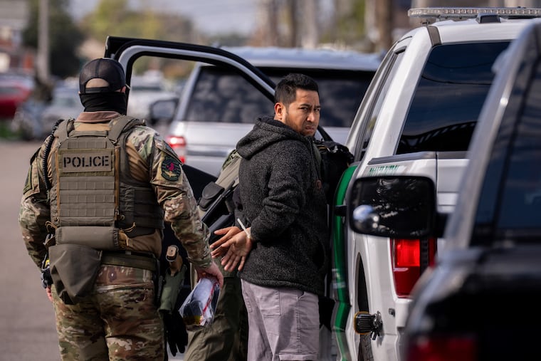 TOPSHOT - A person is detained by US Customs and Border Patrol (CBP) and other federal law enforcement agents in New Orleans, Louisiana, on December 3, 2025. The US Department of Homeland Security announced on Wednesday it has launched a federal immigration enforcement operation, named "Operation Catahoula Crunch," in the New Orleans, Louisiana, area.