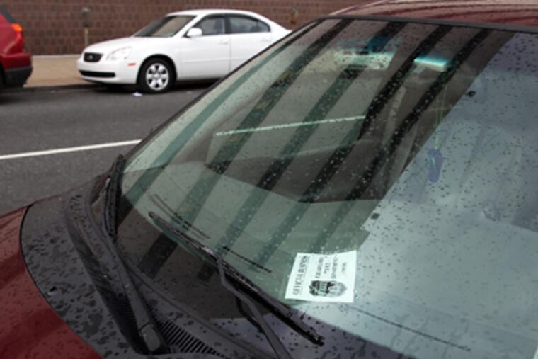 A personal vehicle bearing a Philadelphia Police Department pass was parked illegally near Eighth and Race Streets yesterday.