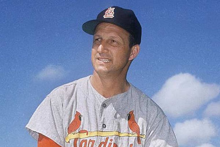 In this March 23, 1964 file photo, Stan Musial visits his former teammates at the St. Louis Cardinals spring training baseball camp in
Florida. Musial, one of baseball's greatest hitters and a Hall of Famer with the Cardinals for more than two decades, died Saturday, Jan. 19, 2013, the team announced. He was 92. (AP file photo)